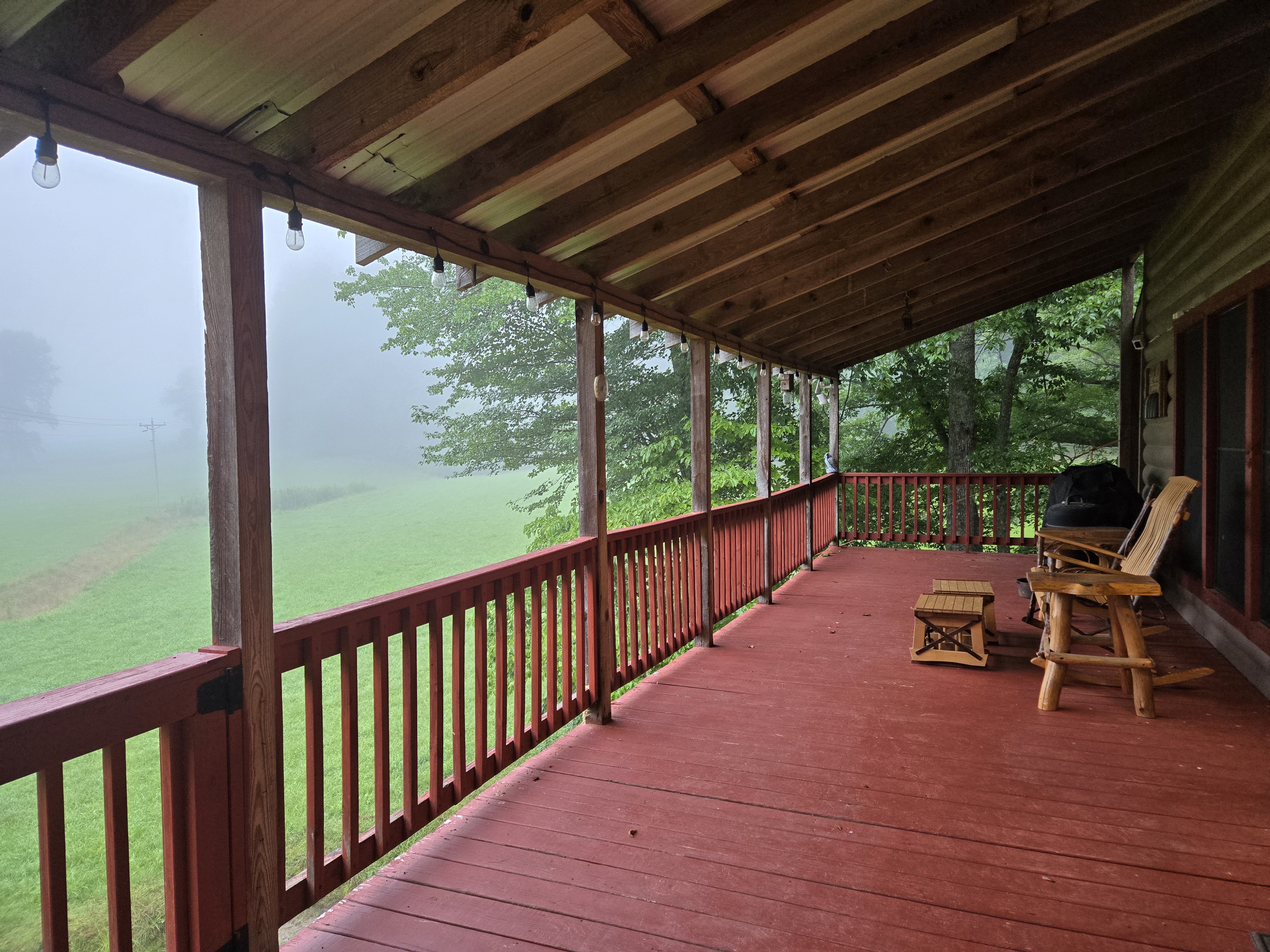 Mist hanging over the valley and pasture viewed from the Headwaters porch in Suches GA — Valley in the Clouds