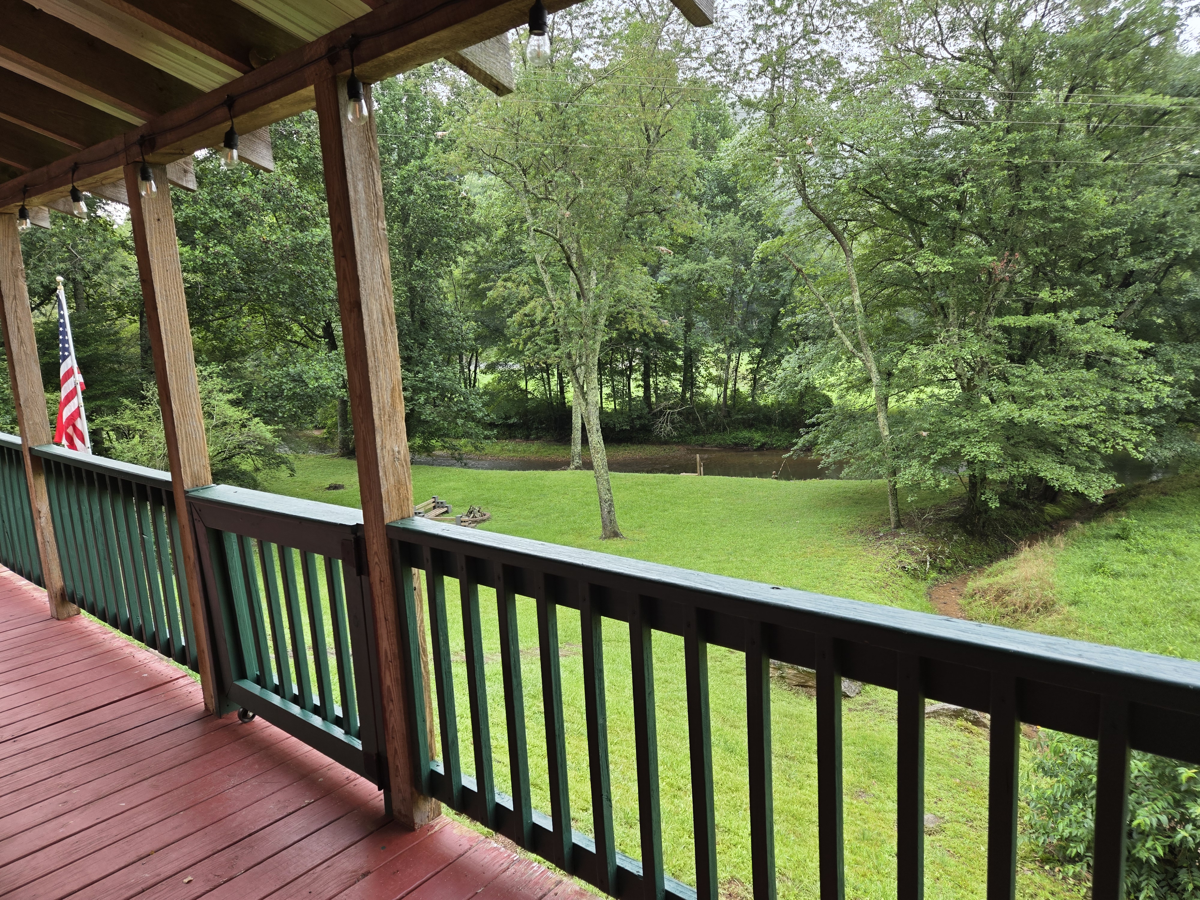 Morning view from the Headwaters porch in Suches GA — green pasture and North Georgia mountain
